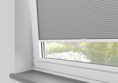 Grey window blinds partially closed
