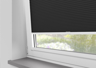 Black window blinds covering sunlight